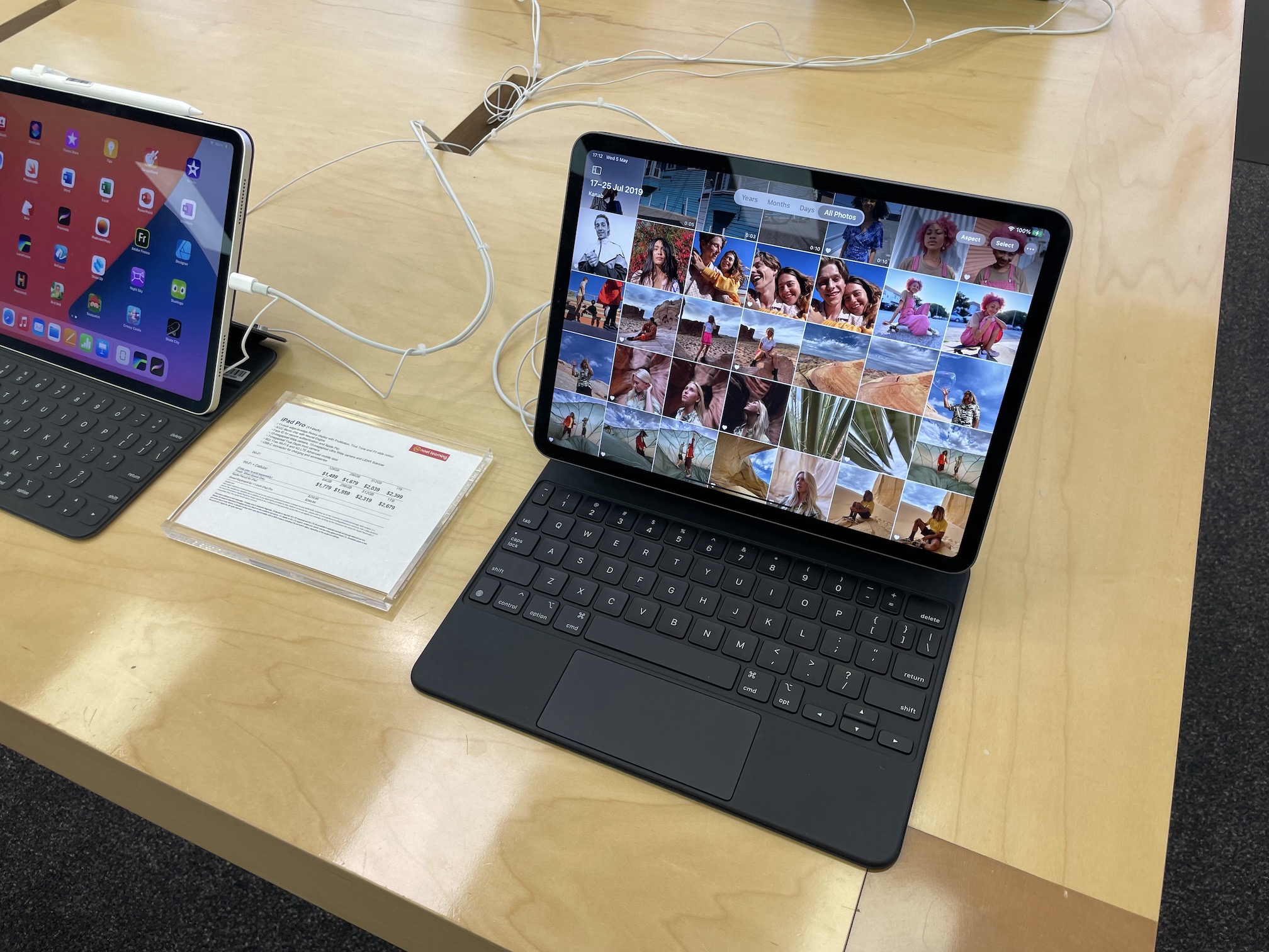 A photo of an iPad Pro set up for display inside of a Noel Leeming store. Visible on the iPad is the Photos app set to the time period spanning 17 - 25th July 2019