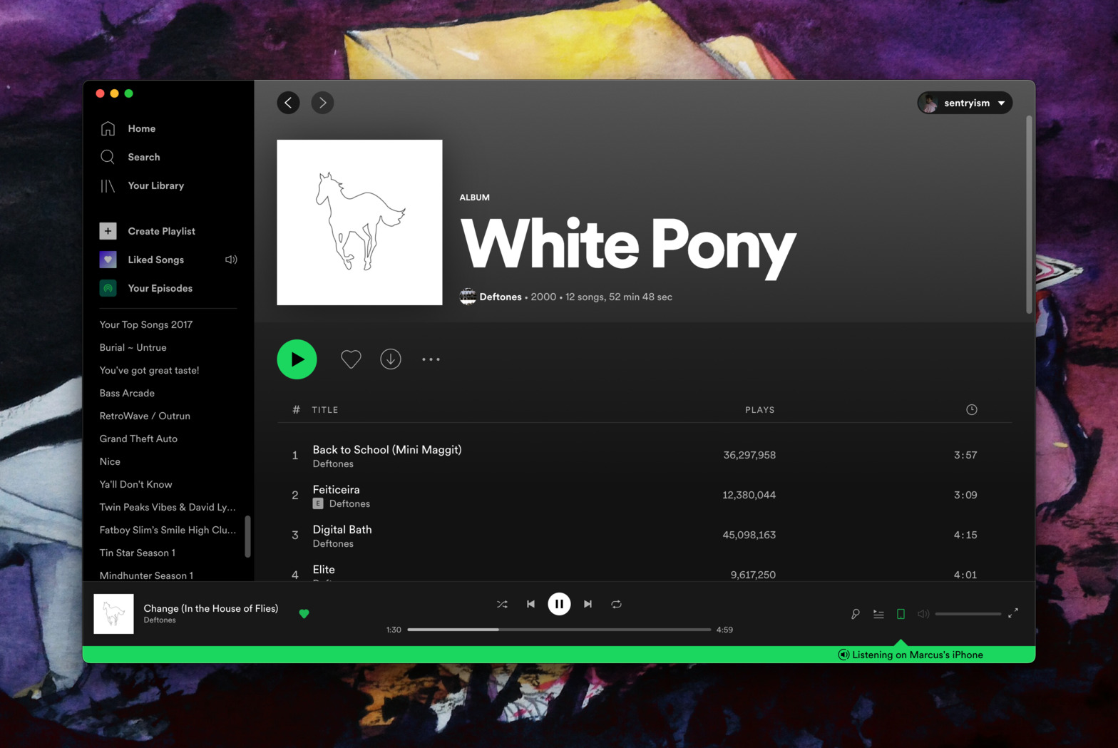 A screenshot of the Spotify desktop client open to the album White Pony by the band Deftones. The track &ldquo;Change (In the House of Flies)&rdquo; is currently playing. At the bottom of the screen is a green banner that says &ldquo;Listening on Marcus&rsquo;s iPhone&rdquo;. This indicates that the user is able to remotely control the session from their desktop.